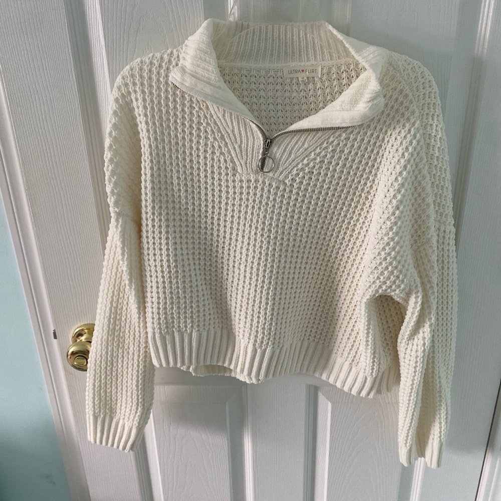 Cream and white quarter zip sweater. Silver hardware with cable knit design.